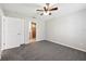 Comfortable bedroom featuring gray carpet, neutral paint, a ceiling fan, and en-suite bathroom at 13489 Sw 60Th Avenue Rd, Ocala, FL 34473