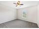 Charming bedroom with gray carpet, neutral walls, a ceiling fan, and natural light from the window at 13489 Sw 60Th Avenue Rd, Ocala, FL 34473