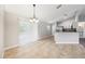 Dining area with tile floors, modern chandelier, and sliding glass doors leading to the outside at 13489 Sw 60Th Avenue Rd, Ocala, FL 34473