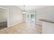 Bright dining area with tile floors, a modern chandelier, and sliding doors leading to outdoor space at 13489 Sw 60Th Avenue Rd, Ocala, FL 34473
