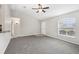 Bright living room with gray carpet, neutral walls, a ceiling fan, and a window for natural light at 13489 Sw 60Th Avenue Rd, Ocala, FL 34473