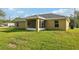 View of home's rear featuring a screened in porch, siding, and well-maintained lawn at 13489 Sw 60Th Avenue Rd, Ocala, FL 34473