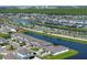 Scenic aerial view of the waterfront community featuring well-manicured lawns and beautiful landscaping at 13617 Haulover Beach Ln, Orlando, FL 32827