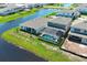 Aerial view showcases a home with screened pool, adjacent to the lake at 13617 Haulover Beach Ln, Orlando, FL 32827