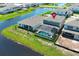 Aerial view showcases a home with screened pool, adjacent to the lake at 13617 Haulover Beach Ln, Orlando, FL 32827