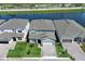 Waterfront home with well-manicured lawn and a paved driveway in a serene lakeside community at 13617 Haulover Beach Ln, Orlando, FL 32827