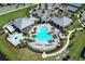 Aerial view of the community pool and amenities center, surrounded by palm trees and lounge chairs at 13617 Haulover Beach Ln, Orlando, FL 32827