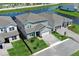 Serene aerial view of a home nestled beside a tranquil lake, complemented by lush greenery and well-kept lawns at 13617 Haulover Beach Ln, Orlando, FL 32827