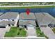 Waterfront home with well-manicured lawn and a paved driveway in a serene lakeside community at 13617 Haulover Beach Ln, Orlando, FL 32827