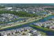 Picturesque aerial view of homes situated along waterways and lush landscaping in a vibrant community at 13617 Haulover Beach Ln, Orlando, FL 32827