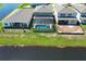 Aerial view of a home with a private screened-in pool and waterfront, perfect for outdoor living and recreation at 13617 Haulover Beach Ln, Orlando, FL 32827