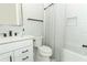 Clean bathroom featuring a white vanity, toilet, bathtub with shower, and matte black fixtures at 13617 Haulover Beach Ln, Orlando, FL 32827
