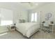 Serene bedroom featuring neutral decor, natural light, and a dedicated workspace with a desk and chair at 13617 Haulover Beach Ln, Orlando, FL 32827