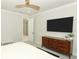 Bedroom with plush carpeting, a media center and adjacent access to the rest of the home at 13617 Haulover Beach Ln, Orlando, FL 32827