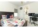 Comfortable bedroom with a sports-themed quilt, a desk, and an ensuite bathroom for added convenience at 13617 Haulover Beach Ln, Orlando, FL 32827