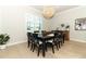 Dining room with seating for eight, light floors, and an accent cabinet at 13617 Haulover Beach Ln, Orlando, FL 32827