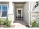 Charming entryway with brick-paved walkway, a wreath on the door, and lush green landscaping at 13617 Haulover Beach Ln, Orlando, FL 32827