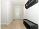 Bright entryway featuring hardwood floors, white trim, coat rack, and storage bench at 13617 Haulover Beach Ln, Orlando, FL 32827