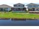 Backyard aerial view of a home with a screened pool near a waterfront, offering privacy and space at 13617 Haulover Beach Ln, Orlando, FL 32827