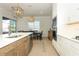 Open-concept kitchen with an island, stainless steel appliances, and a dining area for seamless entertaining at 13617 Haulover Beach Ln, Orlando, FL 32827
