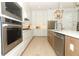 Well-appointed kitchen showcasing stainless steel appliances, white cabinetry, and a kitchen island at 13617 Haulover Beach Ln, Orlando, FL 32827