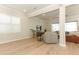 Bright living room with an open floor plan, hardwood flooring, and a view of the outdoor pool at 13617 Haulover Beach Ln, Orlando, FL 32827