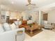 Open-concept living area with a leather sofa and a view to a bright kitchen at 13617 Haulover Beach Ln, Orlando, FL 32827