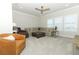 Large living room with sectional sofa, leather chairs, ceiling fan and plenty of natural light at 13617 Haulover Beach Ln, Orlando, FL 32827