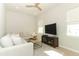 Comfortable living room with white sectional sofa, modern ceiling fan and natural light at 13617 Haulover Beach Ln, Orlando, FL 32827