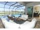 Sparkling pool and lake views from a covered patio, perfect for relaxing and entertaining at 13617 Haulover Beach Ln, Orlando, FL 32827