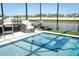 Relaxing pool with a spa and lake view, complemented by comfortable outdoor seating at 13617 Haulover Beach Ln, Orlando, FL 32827