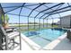 Stunning pool and spa area with comfortable seating and picturesque lake views, set within a screened enclosure at 13617 Haulover Beach Ln, Orlando, FL 32827