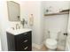 Charming powder room featuring a stylish vanity with gold hardware and a decorative shelf at 13617 Haulover Beach Ln, Orlando, FL 32827