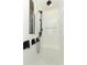A modern shower with white subway tile, black fixtures, a built-in niche, and a shower bench at 13617 Haulover Beach Ln, Orlando, FL 32827