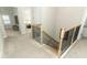 Carpeted staircase with black metal spindles and wooden railing at 13617 Haulover Beach Ln, Orlando, FL 32827
