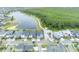 An aerial view shows a blue, two story home in a beautiful lakeside community at 14559 Walcott Ave, Orlando, FL 32827