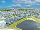 A peaceful aerial view of a neighborhood with a pond and lush landscapes at 14559 Walcott Ave, Orlando, FL 32827