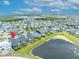 A peaceful aerial view of a neighborhood with a pond and lush landscapes at 14559 Walcott Ave, Orlando, FL 32827