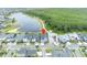 An aerial view shows a blue, two story home in a beautiful lakeside community at 14559 Walcott Ave, Orlando, FL 32827