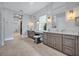 Beautiful primary bathroom featuring dual sinks and vanities with sleek countertops and tile flooring at 14559 Walcott Ave, Orlando, FL 32827
