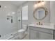 Bright bathroom featuring a glass-enclosed shower, modern vanity with gold fixtures, and stylish mirror at 14559 Walcott Ave, Orlando, FL 32827