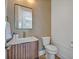 Chic powder room featuring a modern vanity, rectangular mirror and neutral color palette at 14559 Walcott Ave, Orlando, FL 32827