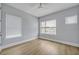 Bright and airy bedroom with three windows offering plenty of natural light and wood flooring for a clean and modern look at 14559 Walcott Ave, Orlando, FL 32827