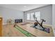 Upstairs loft area with exercise bike, yoga mat, putting green and bright natural light at 14559 Walcott Ave, Orlando, FL 32827