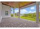 Charming paver patio with ceiling fan, offering serene views of the beautifully landscaped backyard and play set at 14559 Walcott Ave, Orlando, FL 32827