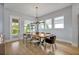 Bright dining area featuring a wood table, modern lighting, and access to the outdoors at 14559 Walcott Ave, Orlando, FL 32827