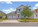 Charming two-story home featuring a two-car garage, balcony, and beautifully landscaped front yard at 14559 Walcott Ave, Orlando, FL 32827