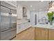 Bright kitchen featuring stainless steel refrigerator, white cabinets, and wood flooring at 14559 Walcott Ave, Orlando, FL 32827