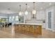 Bright kitchen featuring an island with countertop and stainless steel appliances with a view of the dining area at 14559 Walcott Ave, Orlando, FL 32827