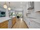 Modern kitchen with stainless steel appliances, a stylish island, and a view of the dining area at 14559 Walcott Ave, Orlando, FL 32827
